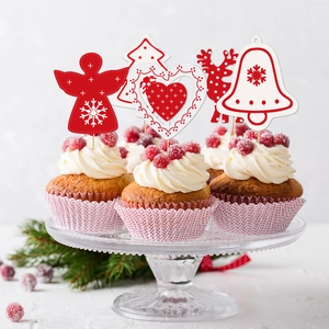 Christmas cupcake toppers with festive reindeer and tree designs on a glass stand