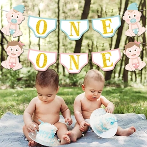 Blue and pink diaper-shaped 'ONE' birthday banners for baby first birthday party decor