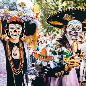 Set of colorful Mexican Day of the Dead masks featuring skull and sombrero for festive parties