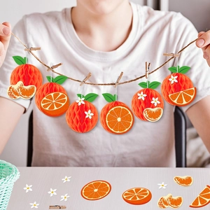 Orange honeycomb tissue paper garland with green leaves for summer party decoration