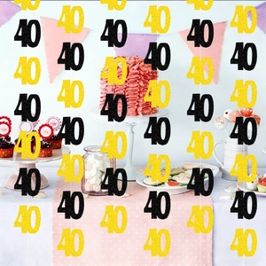 Glittery gold and black number 40 party garlands hanging at a birthday dessert table
