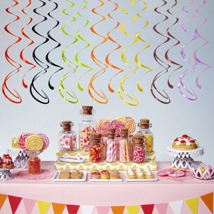 Colorful PVC party swirls hanging over a festive dessert table for birthday celebration