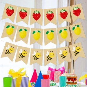 Strawberry and lemon themed burlap banners for summer party decorations in bright room