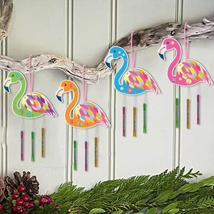 Four colorful flamingo wind chimes with metal tubes hanging on tree branches for garden decor