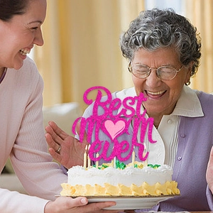 Pink glitter Best Mom Ever cake topper with heart for Mother's Day party celebration