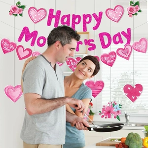 Pink glitter Happy Mother's Day banner and heart decorations in a warm home kitchen