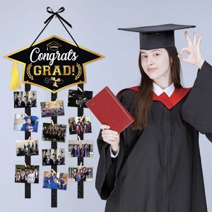 DIY 2026 graduation party photo wall banner with Congrats Grad hat and glitter ribbons