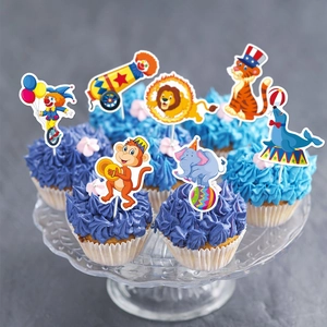 Circus themed cake toppers featuring lion, clown and elephant on blue cupcakes