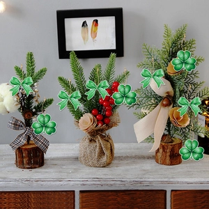 Green St. Patrick's Day clover and bow hanging ornaments on small potted plants