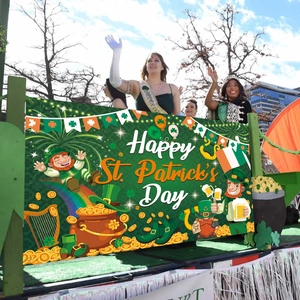 Outdoor parade float with Happy St. Patrick's Day banner featuring leprechaun and clovers