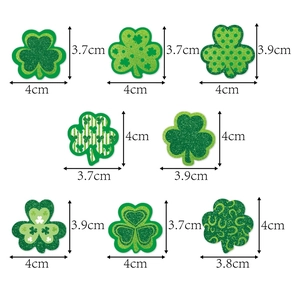 Assorted St. Patrick's Day green clover decorations with glitter and stripe patterns