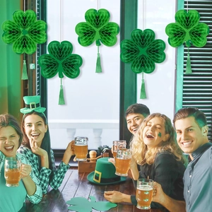 St. Patrick's Day green honeycomb shamrock hanging decorations with tassels in party setting