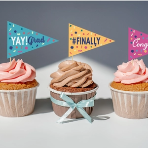 Colorful graduation cupcake toppers featuring Congrats Grad and YAY messages for party decor