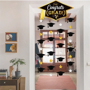 Congrats Grad banner with black graduation caps and gold star hanging decorations