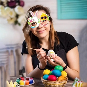 Colorful Easter bunny and chick paper glasses worn by a child in a festive craft setting