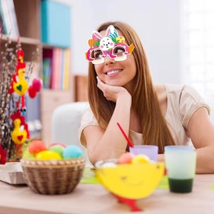 Easter paper glasses featuring bunny ears and colorful eggs for festive party photography