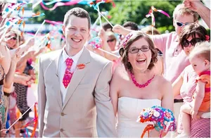 Close-up of colorful handmade fabric flower ball and ribbon wands for wedding celebrations