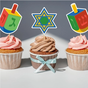Close-up of Hanukkah cupcake toppers featuring Dreidels and Star of David patterns