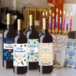 Detailed view of four Hanukkah wine bottle labels featuring Menorah and Star of David motifs