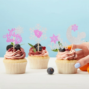 Detail of pink and silver glitter snowflake cupcake toppers for a winter baby shower