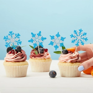 Blue glitter snowflake cupcake topper on a dessert for Christmas and winter party decor