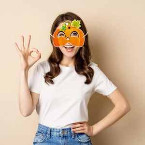Gros plan d'un masque de fête citrouille orange vif avec détail de tournesol et élastique