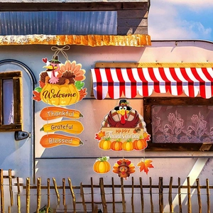 Hanging Thanksgiving turkey door signs with pumpkins and autumn maple leaf decorations