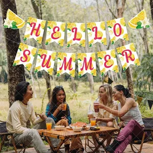 Close-up of Hello Summer banner with lemon prints hanging at an outdoor picnic party