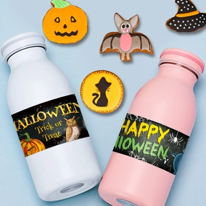 Halloween water bottle stickers with pumpkin owl motifs on pink and white bottles