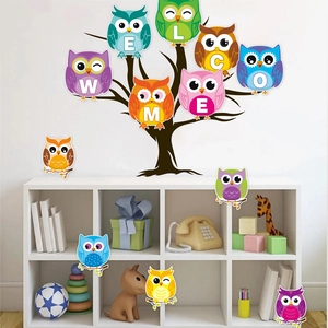 Detail of colorful owl wall stickers forming a welcome message for school classroom decor