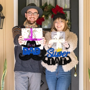 Father's Day party decorations featuring Best Dad and Super Dad hanging door signs