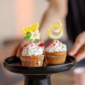 Lemon themed cupcake toppers with citrus slices and white flowers for birthday party decor