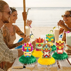 Hawaii Tiki honeycomb centerpieces set on a sunny beach table for summer party decor