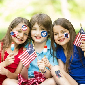 Kids wearing patriotic 4th of July temporary tattoos with flag and heart designs