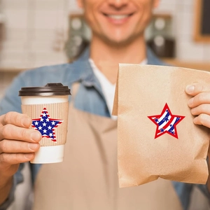 Star-shaped American flag stickers on kraft coffee cup sleeves and gift bags for July 4th