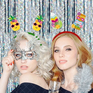 Detail of Hawaii party headbands and Tiki masks worn by models in a festive setting