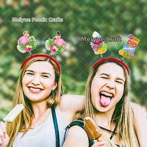 Detail of Hawaii party headband featuring flamingo, surfboard, and tiki mask decorations