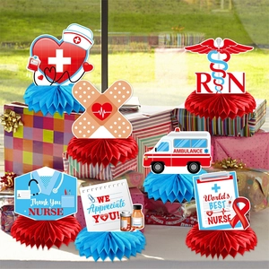 Nurse graduation party table centerpieces with red honeycomb base and medical symbols