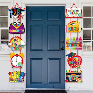 Kindergarten graduation door banners featuring cartoon paper cutouts for party decor