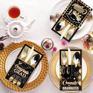Graduation party utensil holders in black and gold design for festive table settings