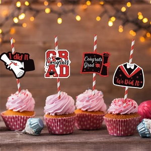 Graduation party straws with glitter mortarboard and congrats grad toppers on a cake