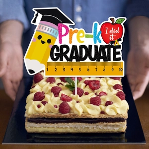 Pre-K graduation cake topper with cute pencil and apple designs on a cream cake