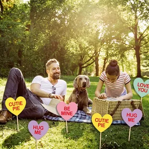 Colorful heart-shaped garden stakes with romantic text for Valentine's Day party decor