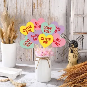 Valentine's Day heart-shaped toppers with romantic quotes in a white ceramic vase