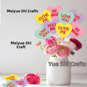 Pastel heart picks with romantic messages in floral arrangement for Valentine decor