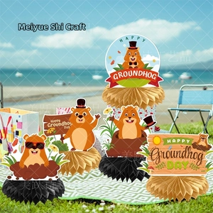 Detailed view of Groundhog Day paper honeycomb centerpieces set for outdoor party tables