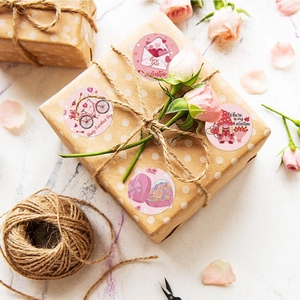 Valentine's Day round stickers with romantic patterns on a decorated gift box with roses