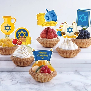 Hanukkah cake toppers with Star of David and Dreidel on fresh fruit tarts background