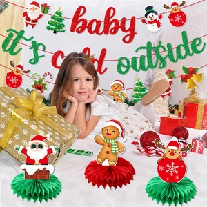 Christmas party decoration set with Baby It's Cold Outside banner and honeycomb centerpieces