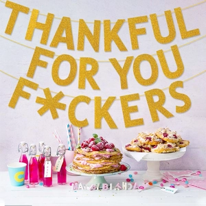 Detail of glittery Thankful For You banner hanging over a festive Thanksgiving table